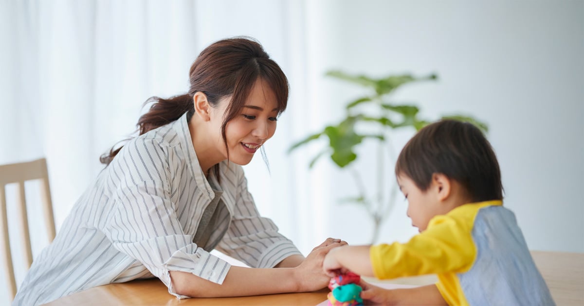 child playing with toys on a table