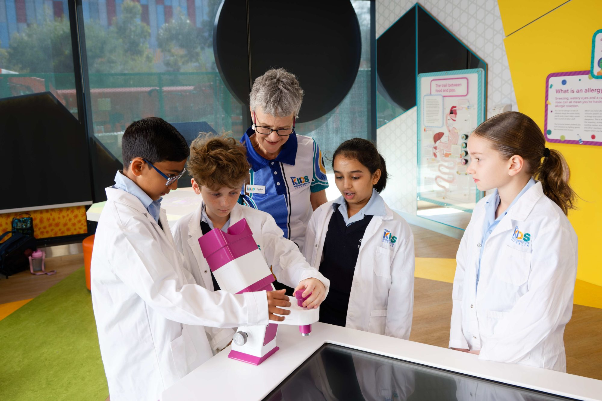 children looking through microscope