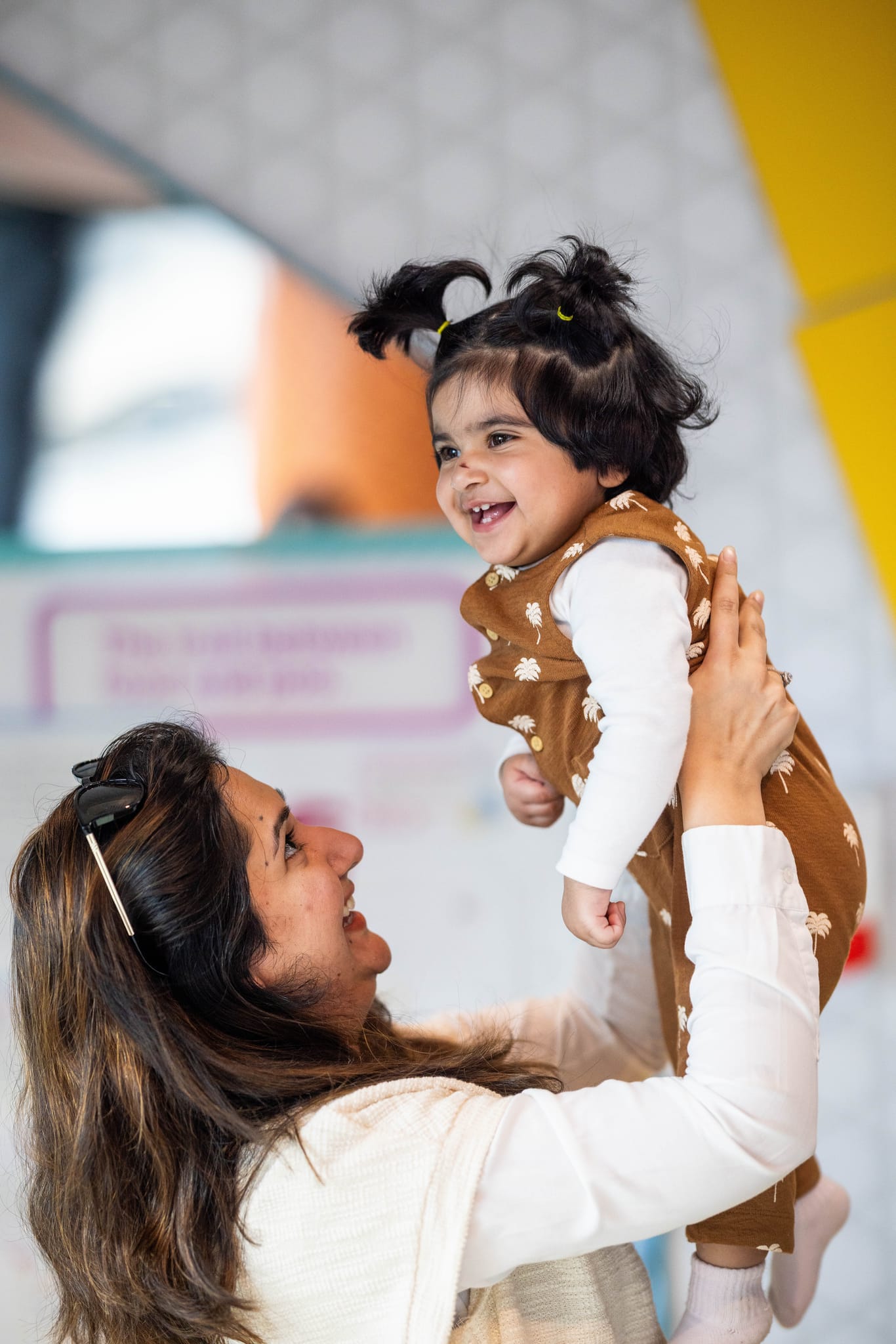 mother holding child in air