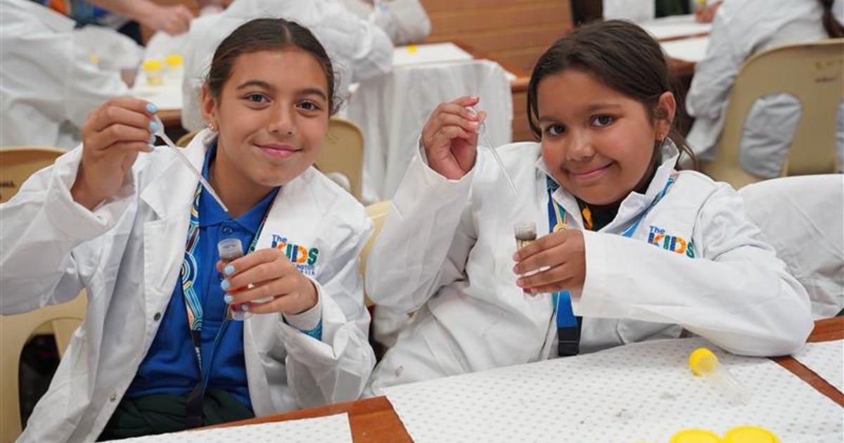 two kids performing a science experiment